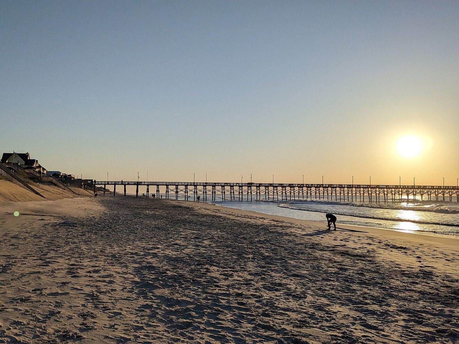 Golden-hour Topsail beach with the pier in the distance